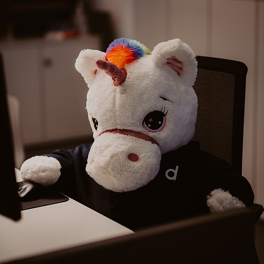 Horni, Feel Good Manager bei der B2B Digitalagentur digit.ly in Hannover, sitzt schwer beschäftigt am Schreibtisch.