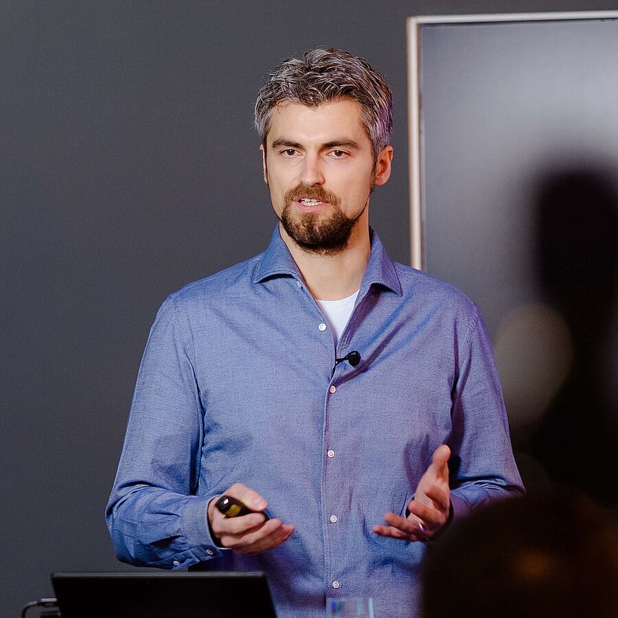 Simon, ehemaliger Geschäftsführer bei der B2B Digitalagentur digit.ly in Hannover steht an seinem Laptop und hält einen Vortrag.